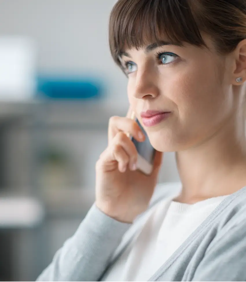 A woman listens to on-hold music while she waits for her call to connect.