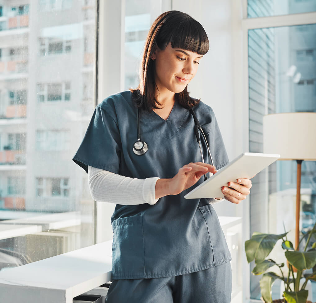 Woman selecting healthcare background music on touchscreen tablet