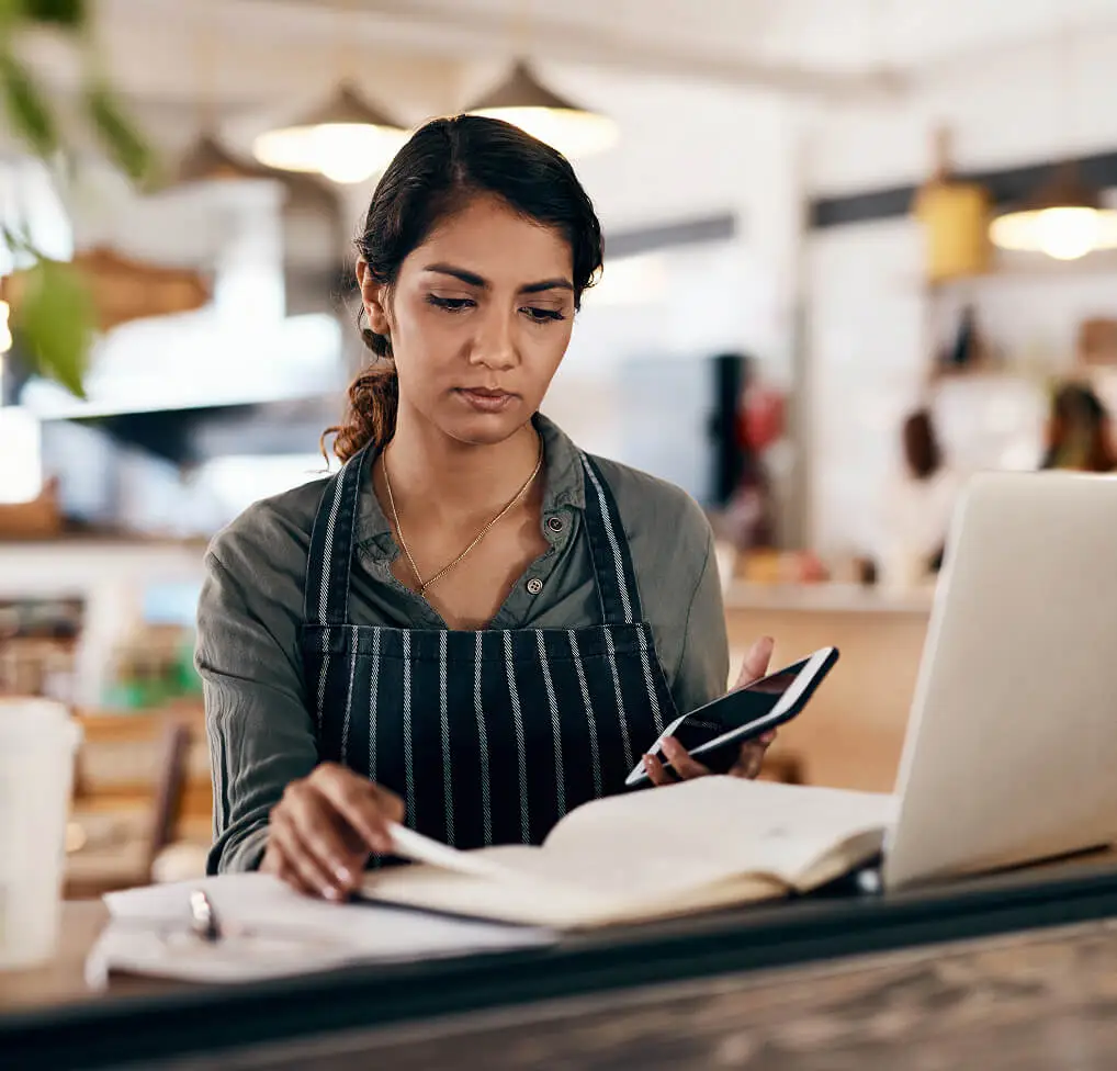 Female restaurant manager selecting music for restaurant franchises