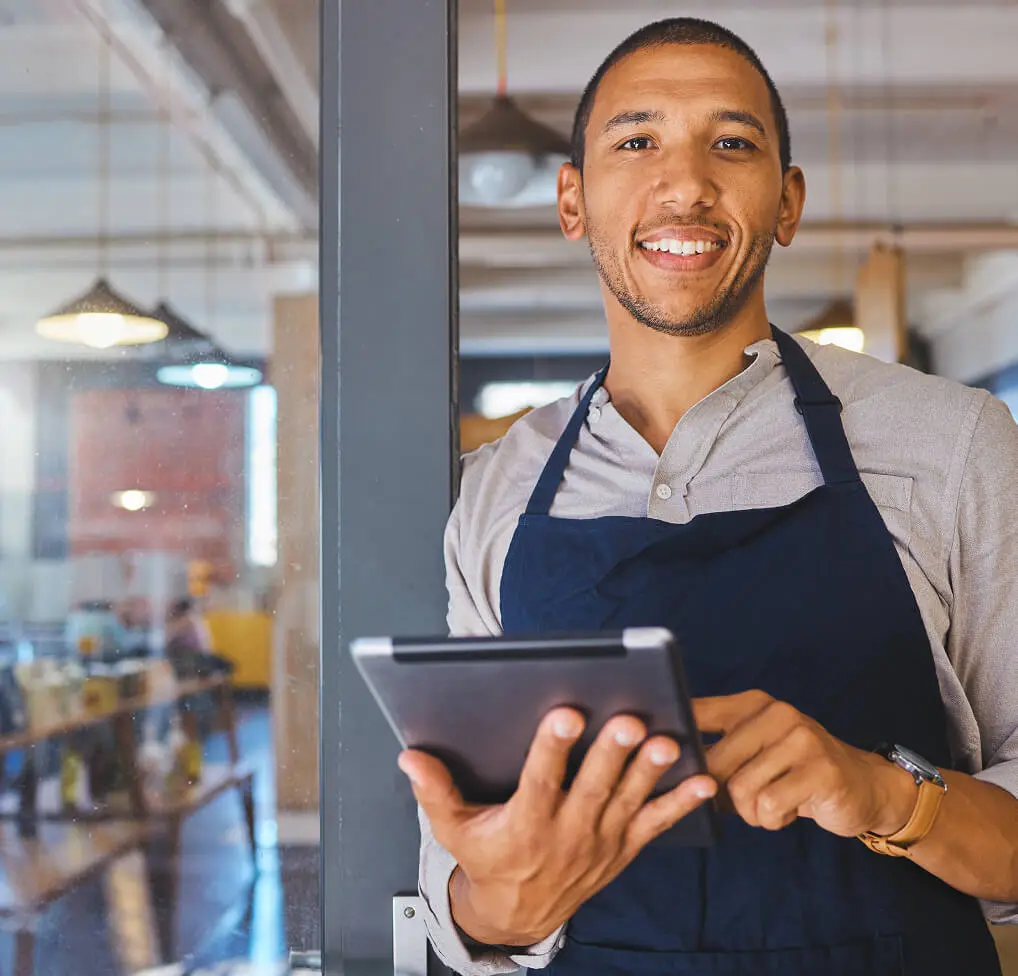 Man selecting music for QSRs on a touchscreen device